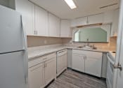 Thumbnail 1 of 12 - kitchen with white cabinets and stainless steel appliances