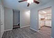 Thumbnail 3 of 12 - an empty living room and kitchen with a ceiling fan