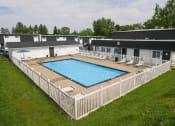 Thumbnail 8 of 12 - an aerial view of a resort style pool in front of a white fence