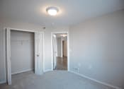 Thumbnail 10 of 17 - a bedroom with a closet and a closet door open