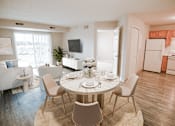Thumbnail 1 of 17 - A dining room with a round table and chairs.