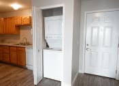 Thumbnail 5 of 17 - a kitchen with white appliances and wooden cabinets