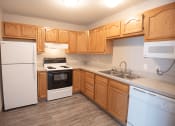 Thumbnail 3 of 17 - a kitchen with white appliances and wooden cabinets