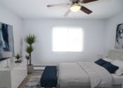 Thumbnail 10 of 18 - a bedroom with a bed and a ceiling fan
