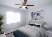 Thumbnail 7 of 18 - a bedroom with a bed and a ceiling fan