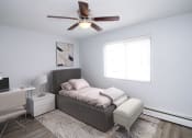 Thumbnail 11 of 18 - a bedroom with a bed and a ceiling fan
