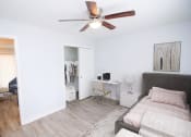Thumbnail 12 of 18 - a bedroom with a ceiling fan and closet