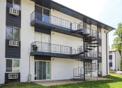 Thumbnail 17 of 18 - an exterior view of an apartment building with a spiral staircase