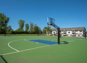Thumbnail 16 of 31 - a basketball court with a house in the background