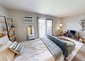 Thumbnail 4 of 30 - A well-lit bedroom with a large bed and a television.