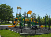 Thumbnail 17 of 31 - a playground with yellow and green equipment on a sunny day