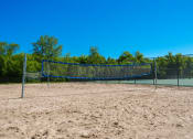 Thumbnail 18 of 31 - a tennis court with a net in the sand