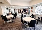 Thumbnail 11 of 21 - a large room with tables and chairs at eden park clubhouse