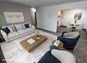 Thumbnail 1 of 21 - A modern living room with a white sofa, a grey armchair, and a wooden coffee table.