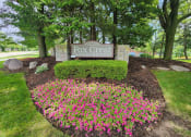 Thumbnail 27 of 30 - sign for Fox Crest Apartment with flowers