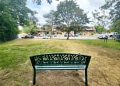 Thumbnail 14 of 30 - a park bench sitting in the grass