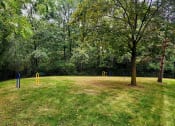 Thumbnail 16 of 30 - a park with a playground and a tree