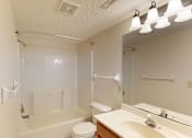 Thumbnail 14 of 34 - A white bathroom with a toilet, sink, and bathtub.