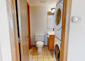 Thumbnail 19 of 34 - A small laundry room with a washer and dryer.