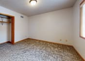 Thumbnail 16 of 34 - A room with a carpeted floor and a door on the left.