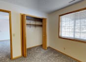 Thumbnail 13 of 34 - A room with a closet and a window.