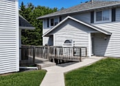 Thumbnail 25 of 34 - A house with a grey siding and a white window.
