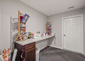Thumbnail 17 of 23 - a room with a desk with gift wrapping materials and other items on it