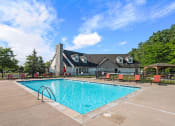 Thumbnail 21 of 23 - a swimming pool with a house in the background