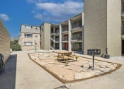 Thumbnail 14 of 20 - a picnic table in front of an apartment building