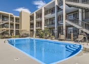 Thumbnail 17 of 20 - a swimming pool in front of an apartment building