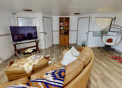 Thumbnail 9 of 20 - a clubhouse room with a couch and a television