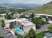 Thumbnail 19 of 30 - A large building with a pool in the middle of a parking lot.