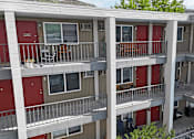 Thumbnail 27 of 30 - Apartment building with red doors and balconies.