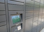 Thumbnail 17 of 30 - A grey mailbox with a screen showing the Amazon logo.