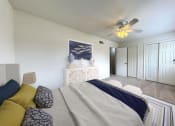 Thumbnail 5 of 17 - a bedroom with a bed and a ceiling fan