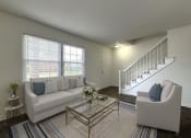 Thumbnail 2 of 17 - a living room with a white couch and a staircase