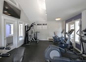 Thumbnail 13 of 17 - A spacious home gym with a variety of exercise equipment.