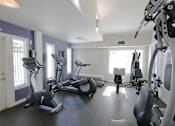 Thumbnail 14 of 17 - A gym with a variety of exercise equipment including treadmills, stationary bikes, and weight machines.