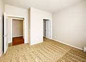 Thumbnail 16 of 25 - A room with carpeted floor and two doors.