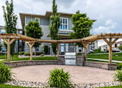 Thumbnail 25 of 25 - A modern house with a covered patio area.