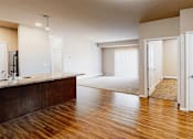 Thumbnail 5 of 25 - A kitchen with a wooden floor and a counter.