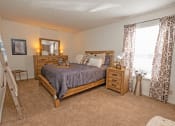 Thumbnail 11 of 20 - a bedroom with a bed and dresser