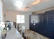 Thumbnail 18 of 27 - a long table with chairs in a room with lockers and a window
