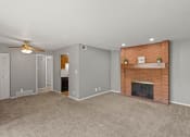 Thumbnail 1 of 23 - the living room of an apartment with a brick fireplace