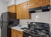 Thumbnail 7 of 23 - a kitchen with a stove and a refrigerator