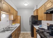 Thumbnail 5 of 23 - apartment kitchen with a stove sink and refrigerator