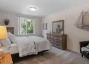 Thumbnail 10 of 25 - a bedroom with a bed and a dresser