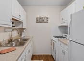 Thumbnail 14 of 25 - a kitchen with white cabinets and white appliances