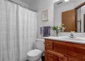 Thumbnail 7 of 24 - a bathroom with a toilet and a sink and a shower