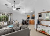 Thumbnail 9 of 24 - a living room with a couch and a table
